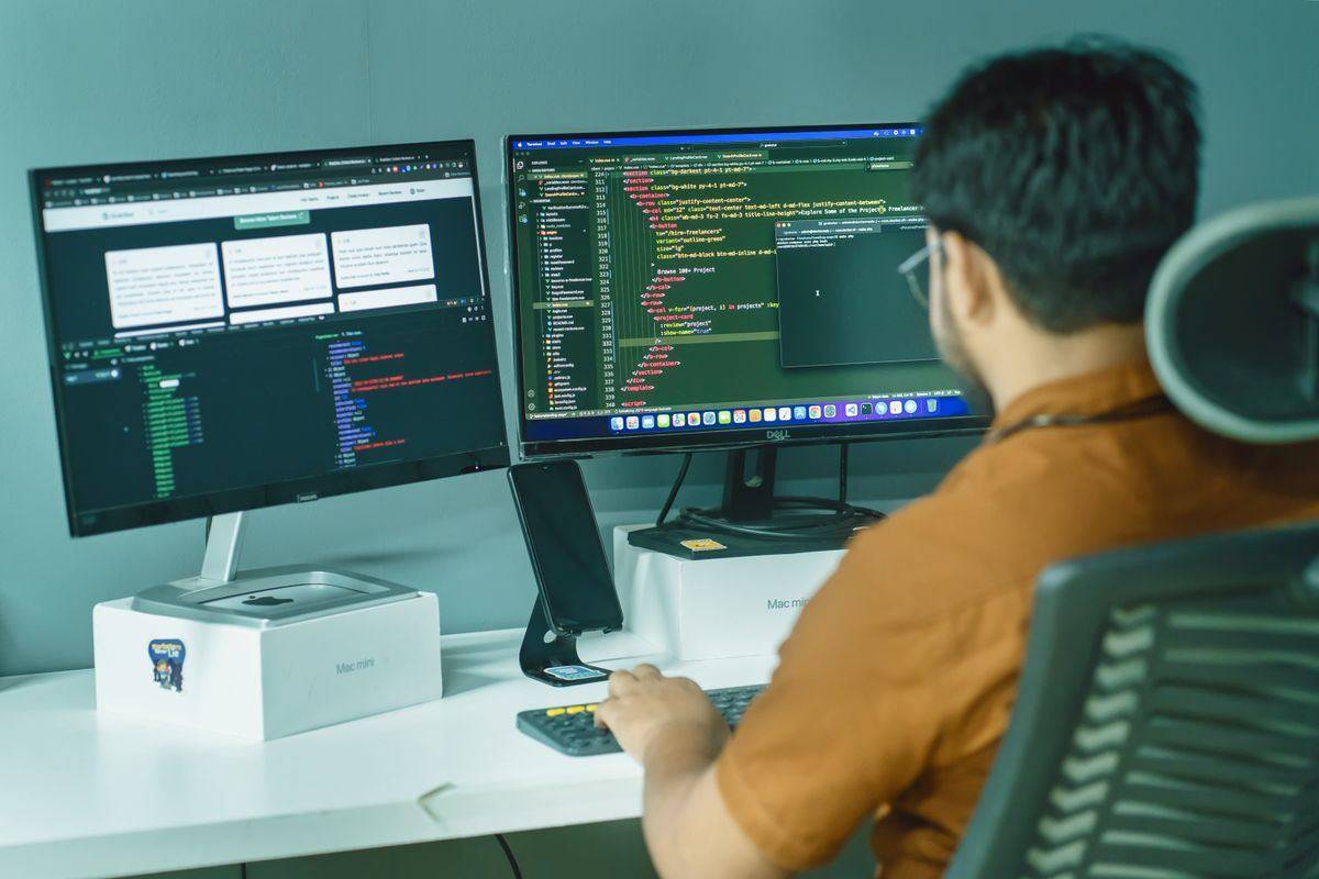 Developer at a desk with two monitors