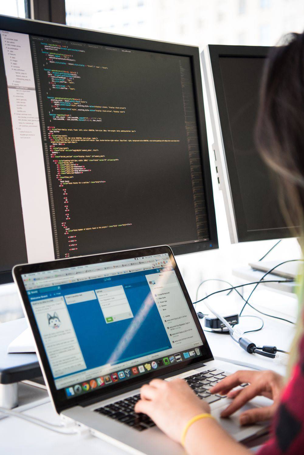 Programmer working across multiple screens